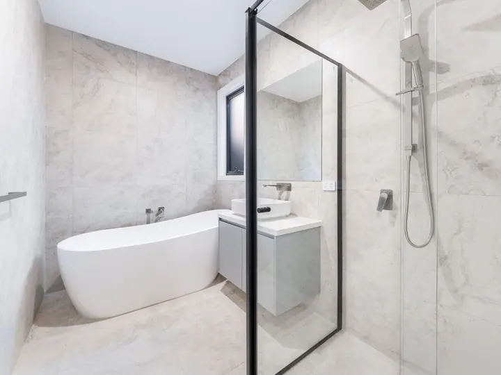 Bathroom with a freestanding bath and walk-in shower, in the Aspen 25, built by Oakview at Oak Grove, Clyde North