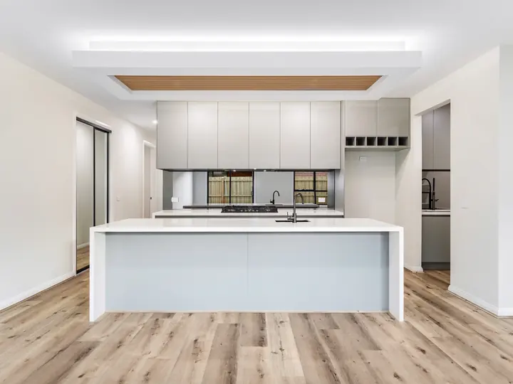 Kitchen island with a stone top, in the Aspen 25, built by Oakview at Oak Grove, Clyde North