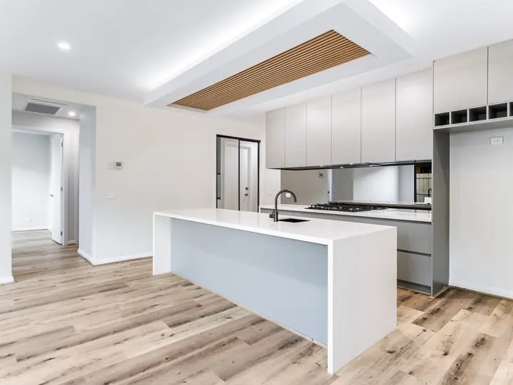 Kitchen island and cabinetry from the side, in the Aspen 25, built by Oakview at Oak Grove, Clyde North