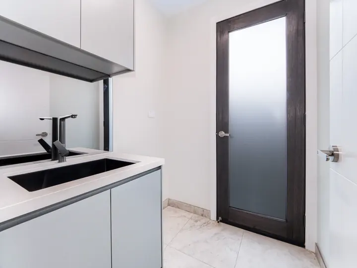 Laundry with a black mixer and frosted door, in the Aspen 25, built by Oakview at Oak Grove, Clyde North