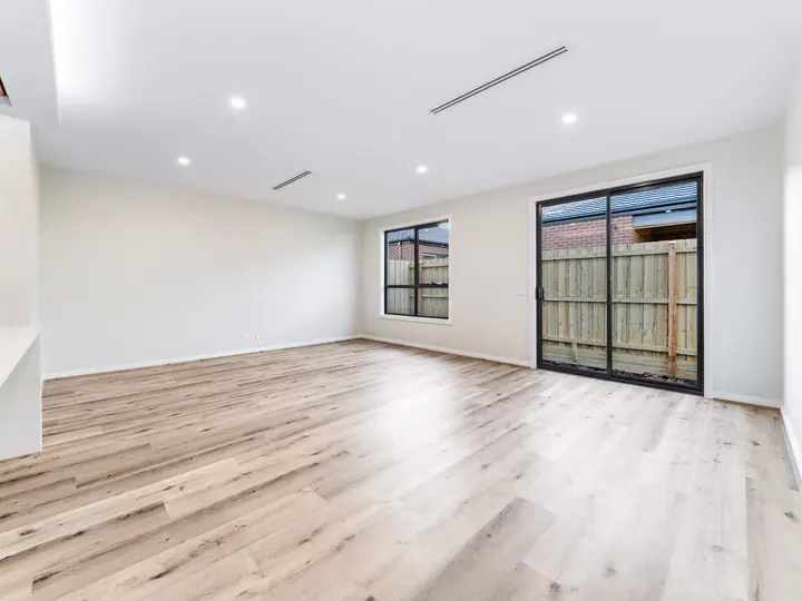 Living room with sliding doors to the yard, in the Aspen 25, built by Oakview at Oak Grove, Clyde North