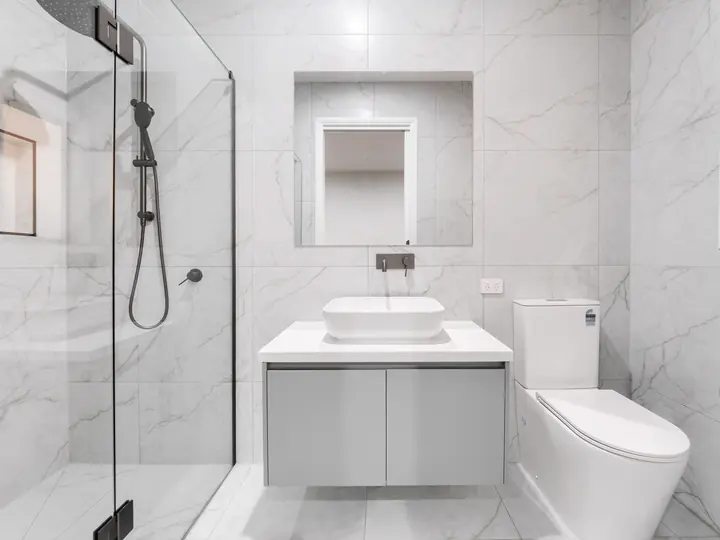 Bathroom with a floating vanity and frameless shower, in a single-storey home Oakview built in Clyde North