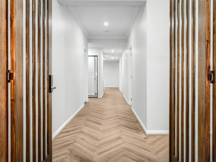 Hallway framed by timber battens, in a single-storey home Oakview built in Clyde North