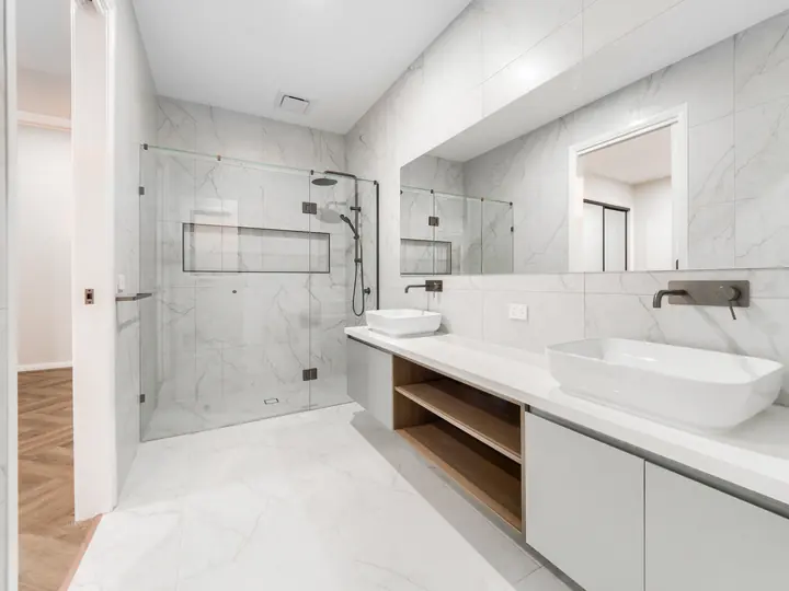 Ensuite with a frameless shower and double vanity, in a single-storey home Oakview built in Clyde North