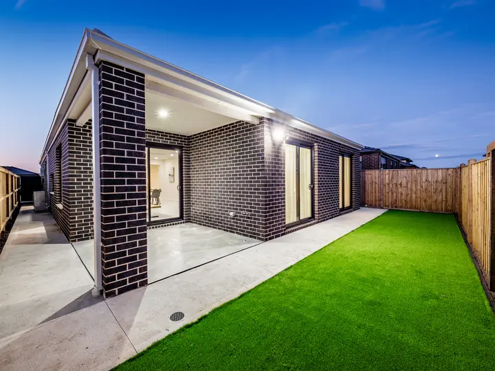 Rear yard and alfresco with timber fencing, in a family home Oakview built in Clyde North