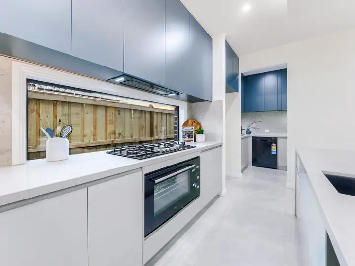 Gas cooktop with a window splashback, in a family home Oakview built in Clyde North