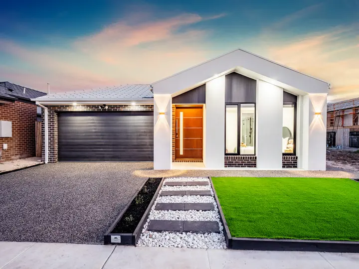 The facade at dusk, in a family home Oakview built in Clyde North