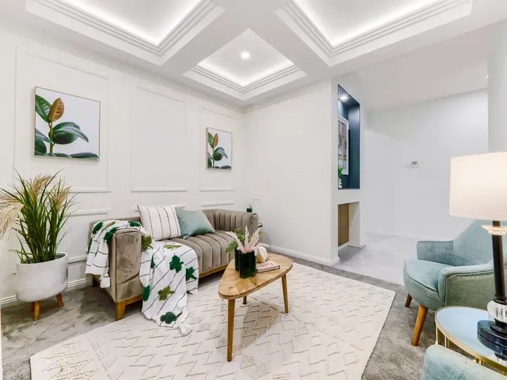 Lounge with panelled walls and a coffered ceiling, in a family home Oakview built in Clyde North