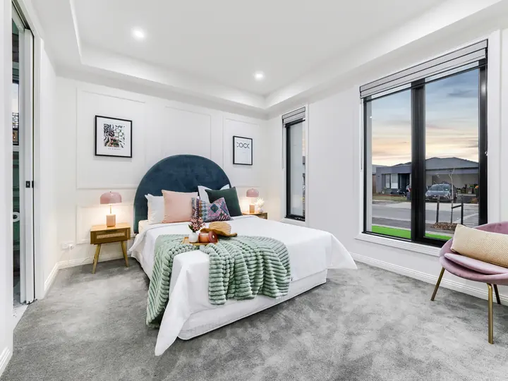 Main bedroom with a curved bedhead, in a family home Oakview built in Clyde North