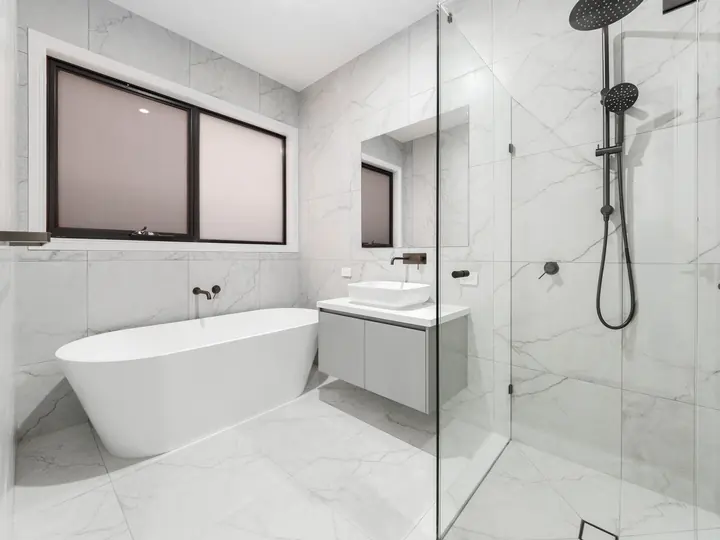 Bathroom with a freestanding bath and walk-in shower, in a single-storey home Oakview built in Clyde North