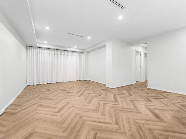 Living room with a raked ceiling, in a single-storey home Oakview built in Clyde North