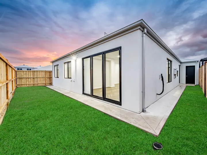 Rear yard with sliding doors to the living room, in a single-storey home Oakview built in Clyde North