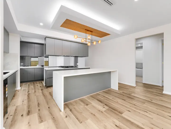 Timber-batten bulkhead above the kitchen, in a custom home Oakview finished in brushed gold fittings