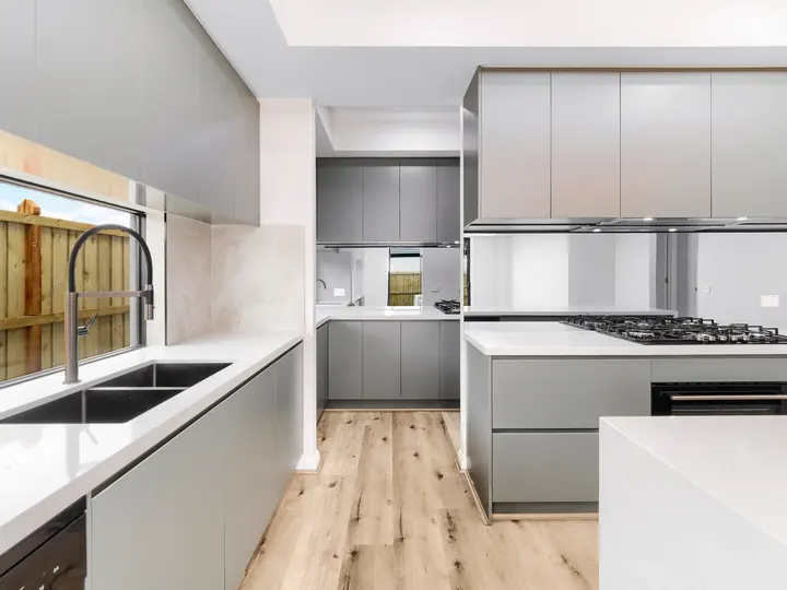 Kitchen sink and gooseneck mixer, in a custom home Oakview finished in brushed gold fittings
