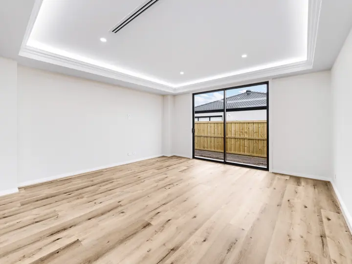 Living room with an LED-lit bulkhead, in a custom home Oakview finished in brushed gold fittings