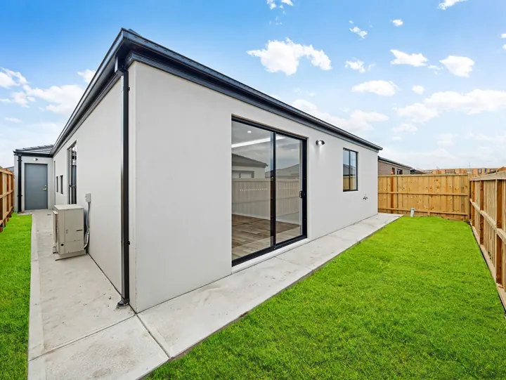 Rear of the home with sliding doors to the yard, in a custom home Oakview finished in brushed gold fittings