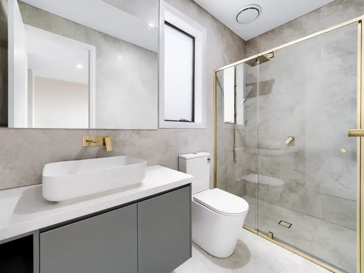 Vanity with brushed gold tapware, in a custom home Oakview finished in brushed gold fittings