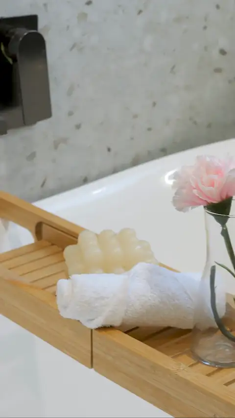 Moving close-up of a bath tray across the freestanding bath in a family home built by Oakview Homes in Clyde North