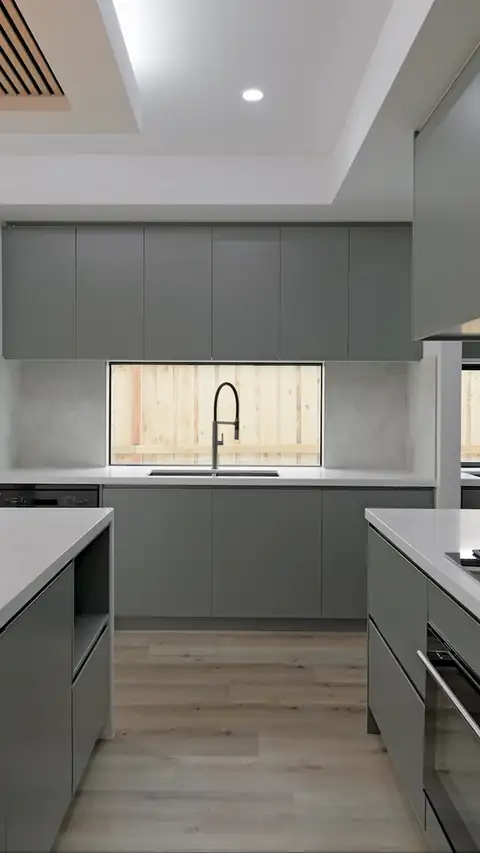 Moving view of the globe pendant over the kitchen island in a gold-finish home built by Oakview Homes