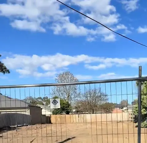 The cleared block behind temporary fencing after demolition, at Oakview's knockdown rebuild site in Seaford