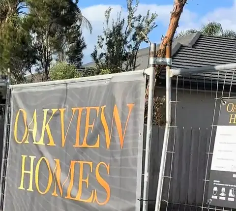 Oakview Homes banner on the site fence after demolition, at Oakview's knockdown rebuild site in Seaford