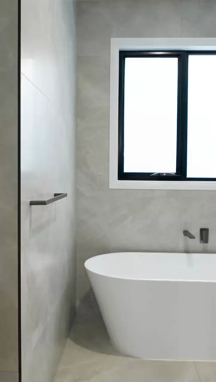 Freestanding bath under a window, in the Sienna 23 by Oakview Homes