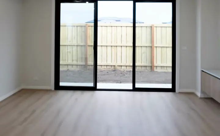 Living room with sliding doors to the yard, in the Sienna 23 by Oakview Homes