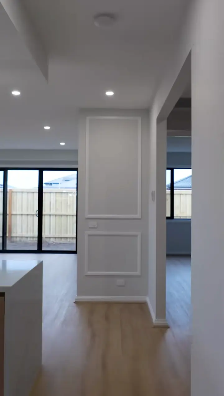 Panelled wall between kitchen and living, in the Sienna 23 by Oakview Homes